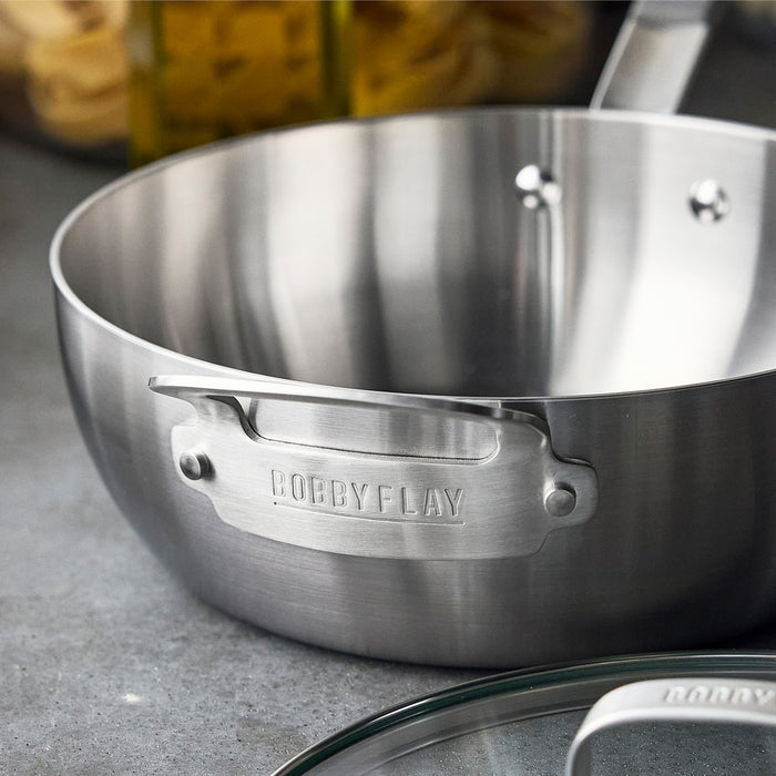 Stainless steel chefs pan with lid and engraved handle, 3.57-quart capacity.