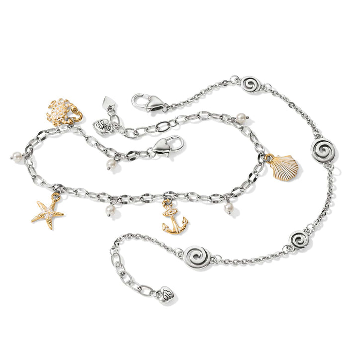 Brighton charm bracelet and anklet set with silver-plated swirls, brushed gold sea charms, and glass pearls on a white background