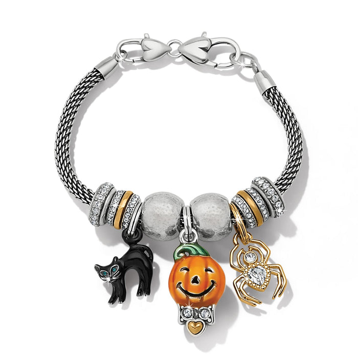 Brighton charm bracelet with silver-plated mesh chain, enamel black cat, pumpkin, and gold-tone spider charms on a white background