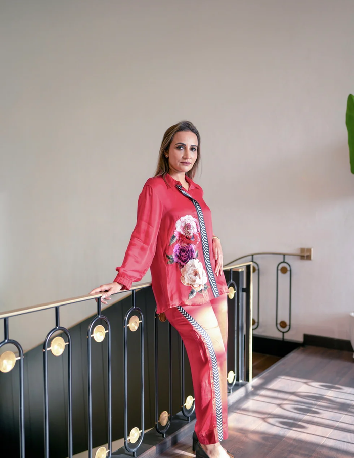 Rosette Bloom Co-Ord Set featuring a vibrant floral print shirt with patterned stripe detailing and matching trousers for effortless contemporary elegance.