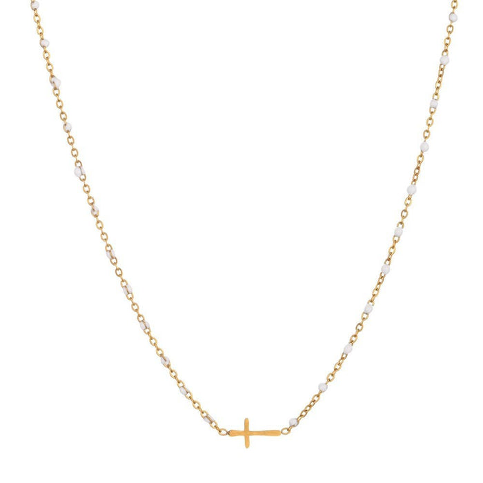 Gold necklace with a small cross pendant on a white background