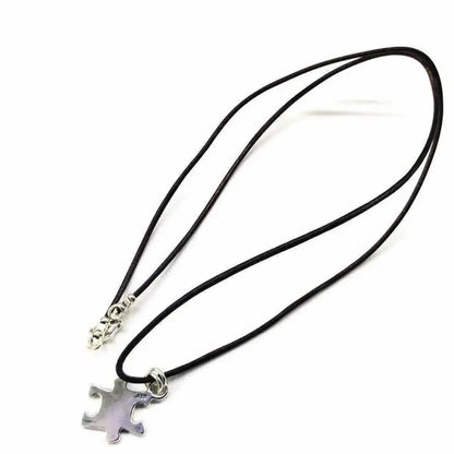 925 Silver Autism Awareness Puzzle Piece Leather Necklace on a black cord, featuring a silver puzzle piece pendant.