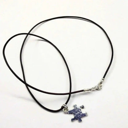 925 Silver Autism Awareness Puzzle Piece Leather Necklace featuring a rustic puzzle piece pendant on a leather cord.