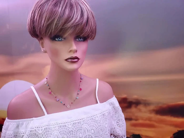 Adjustable Golden Wire Wrapped Kunterbunt Gemstone Necklace displayed on a mannequin against a scenic background.