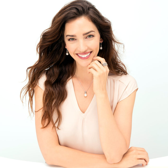Model wearing a Brighton silver-plated pearl pendant necklace with coordinating pearl drop earrings and heart-motif ring