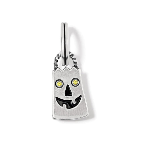 Brighton silver-plated charm shaped like a ghost with yellow crystal eyes and black enamel smile on a white background