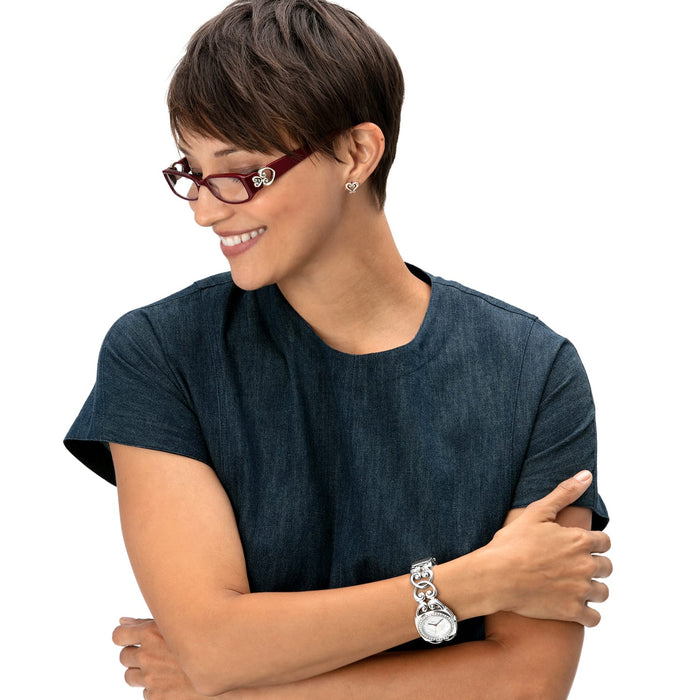 Model wearing Brighton red rectangular eyeglasses with silver scroll temple detail and coordinating Brighton accessories