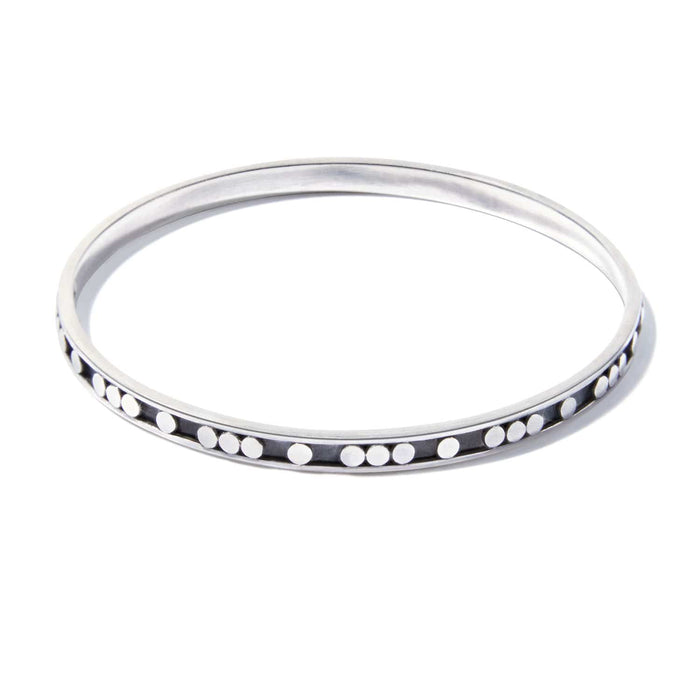 Brighton bangle bracelet in sterling silver with raised dot detailing along the outer edge on a white background