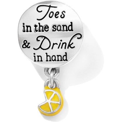 Brighton silver-plated charm engraved with beach quote and dangling yellow enamel lemon slice on a white background