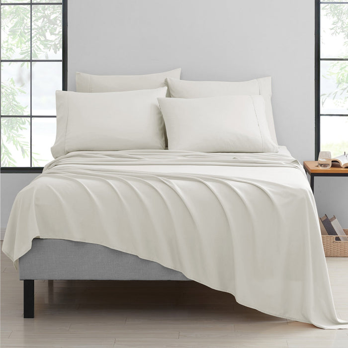 A 6-piece bamboo bed sheet set in ivory color, displayed on a bed with pillows and a flat sheet.