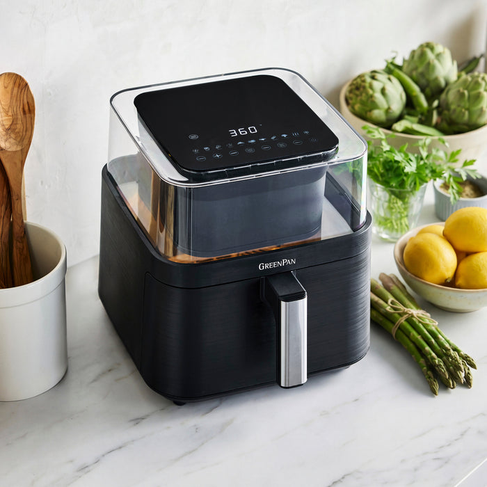 Clear Bistro 7-quart air fryer on a kitchen counter with lemons, asparagus, and artichokes nearby.