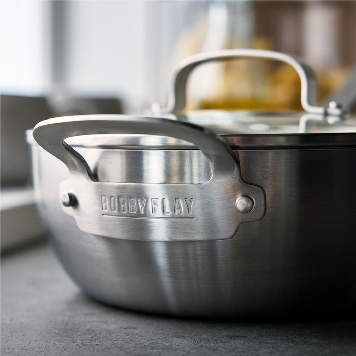 Stainless steel chef’s pan with lid on a kitchen counter, 3.57-quart capacity, by GreenPan.