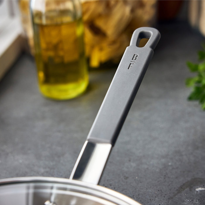 Stainless steel chefs pan with BF engraved on the handle, shown on a kitchen counter. 3.57-quart size by GreenPan.