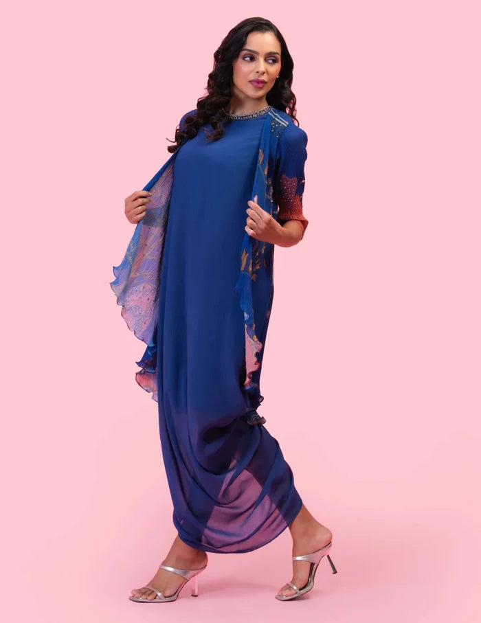 Model wearing the 'BRAHMAND BLUE' DRAPED DRESS WITH OVERLAY JACKET featuring an embroidered neckline and a printed micro-pleated Georgette jacket