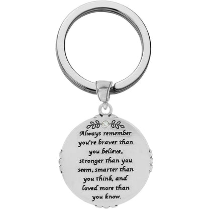 Brighton keychain with round silver-tone charm engraved with inspirational message and crystal accent on a white background