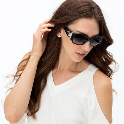 Model wearing Brighton black cat-eye sunglasses with crystal embellishments on the temples and gradient lenses