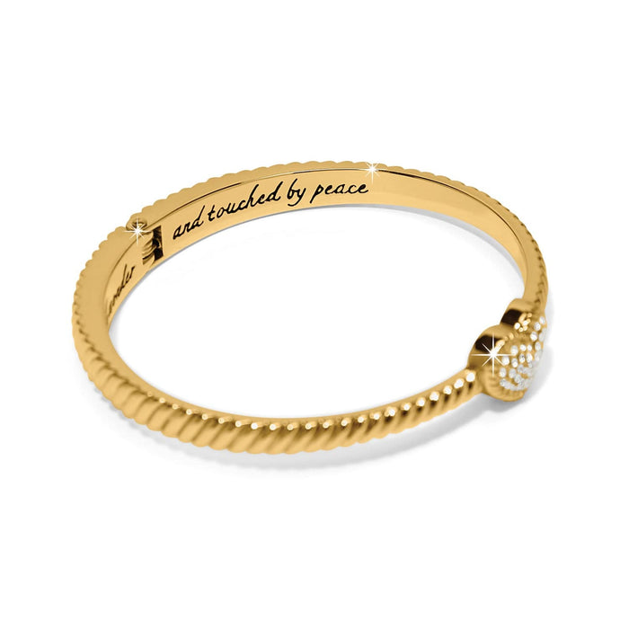 Brighton bangle bracelet with gold-tone twisted rope design, crystal heart accent, and engraved inscription on a white background