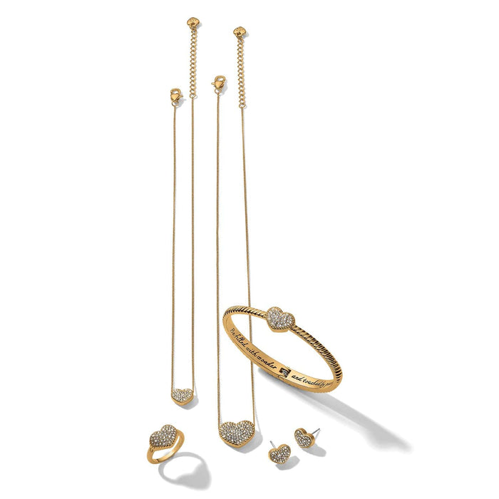 Brighton jewelry set with gold-tone heart necklaces, pavé crystal bangle, heart ring, and stud earrings on a white background