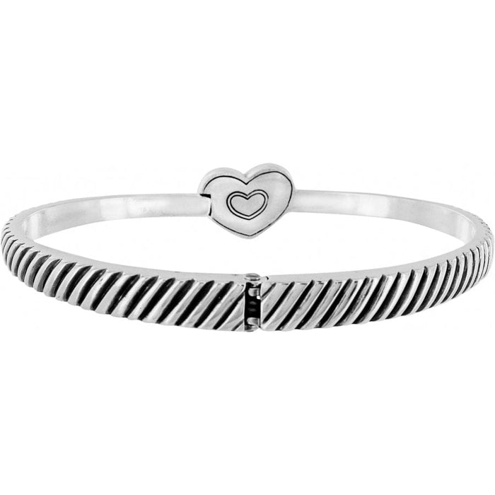 Brighton bangle bracelet with silver-plated ribbed texture and heart-shaped clasp on a white background