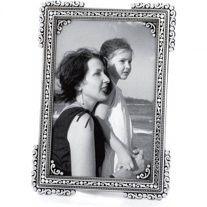 Brighton picture frame with silver-plated ornate scroll and beaded border holding a black and white photo on a white background