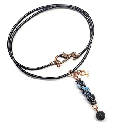 Child Abuse Awareness Agate Necklace With Lava Rock Bead featuring blue agate beads and copper accents.