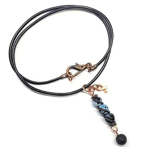 Child Abuse Awareness Agate Necklace With Lava Rock Bead featuring blue agate beads and copper accents.