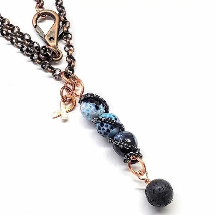 Child Abuse Awareness Agate Necklace With Lava Rock Bead featuring blue agate beads and lava rock charm on a copper chain.