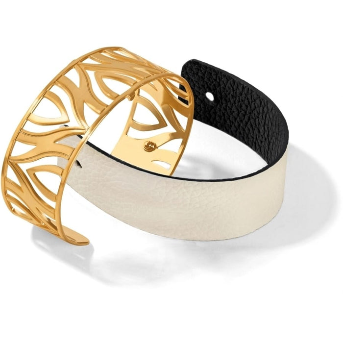 Brighton bracelet set with gold-plated cutout cuff and white leather strap with black accent on a white background