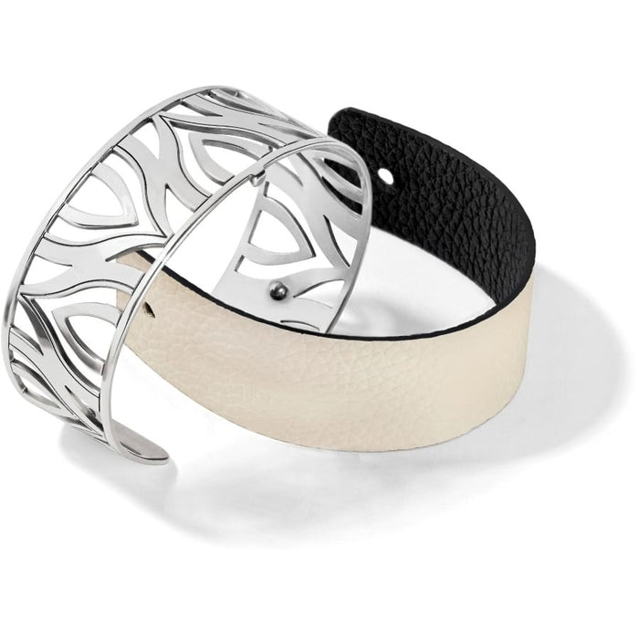 Brighton cuff bracelet with silver-plated cutout design and reversible black and cream leather band on a white background