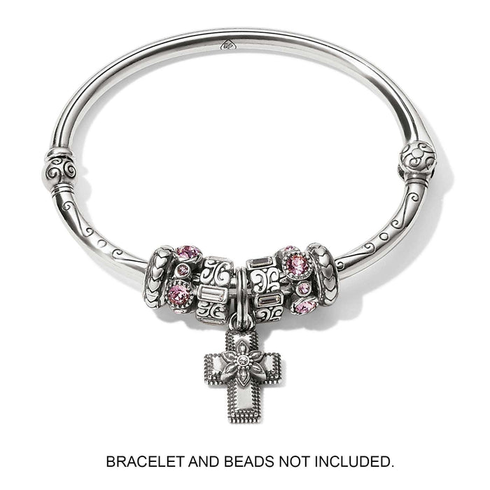 Brighton silver-plated cross charm with flower detail and crystal center, displayed on bangle with beads, on a white background