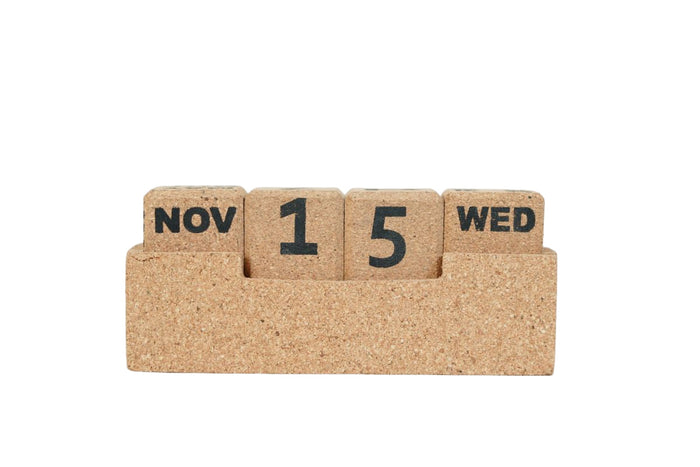 Cork calendar block with 'Nov 15 Wed' on a white background