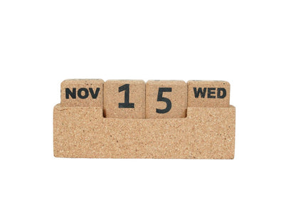 Cork calendar block with 'Nov 15 Wed' on a white background