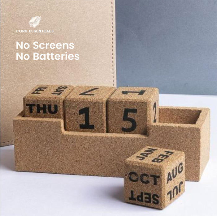 Cork calendar blocks with days of the week on a white surface, branded 'Cork Essentials'.