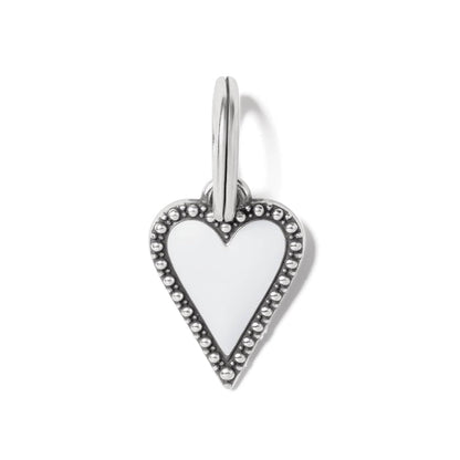 Brighton heart charm with white enamel center and silver-plated beaded border with split ring on a white background