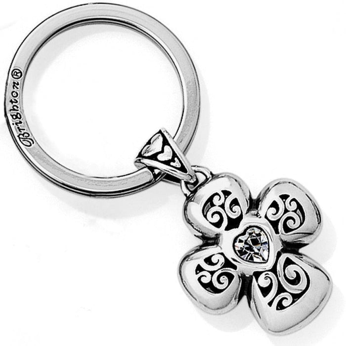 Brighton keychain with silver-plated four-petal flower charm, scroll cutouts, and crystal heart center on a white background