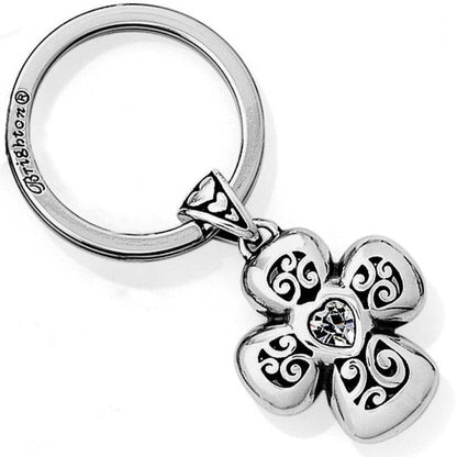Brighton keychain with silver-plated four-petal flower charm, scroll cutouts, and crystal heart center on a white background
