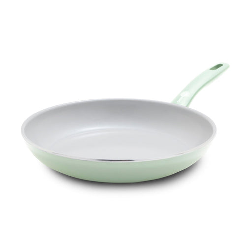 Pastel green ceramic nonstick 10-inch frypan with matching handle, displayed on a white background.