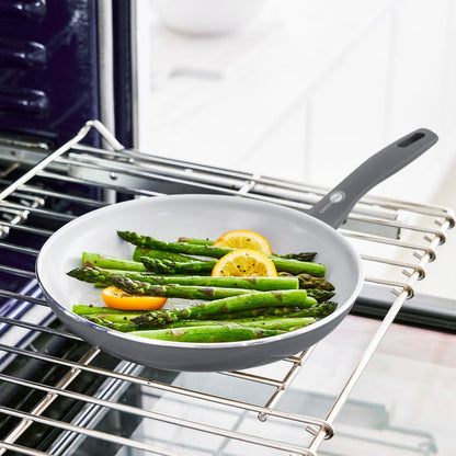 Ceramic nonstick frypan from Dover set on an oven rack in a bright kitchen, one pan visible from the 8, 10, 12 set.