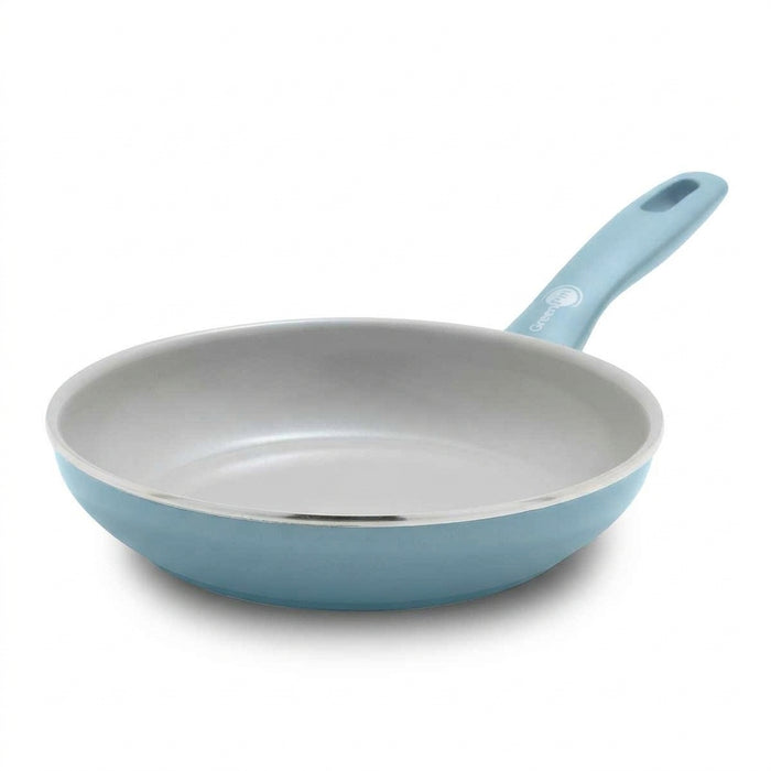 Blue ceramic 8-inch frypan with white interior and matching spatula, aluminum construction.