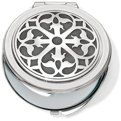 Brighton compact mirror with round silver-tone lid featuring ornate scrollwork medallion design on a white background
