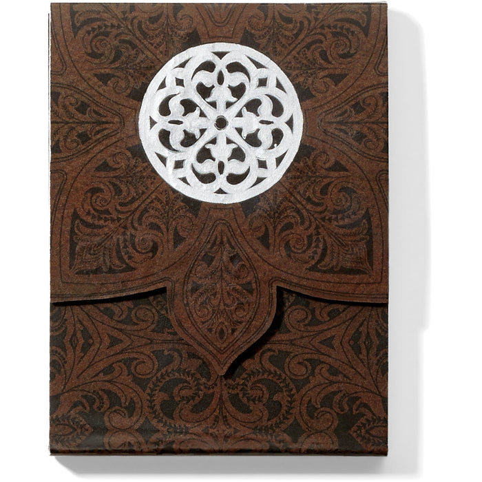 Brighton brown embossed leather journal with scroll patterns and silver-tone medallion emblem on a white background