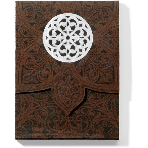 Brighton brown embossed leather journal with scroll patterns and silver-tone medallion emblem on a white background