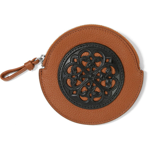 Brighton round leather coin pouch in tan with black ornamental scrollwork medallion and zip closure on a white background