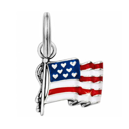Brighton charm featuring an enameled American flag with red, white, and blue design and silver-plated pole on a white background