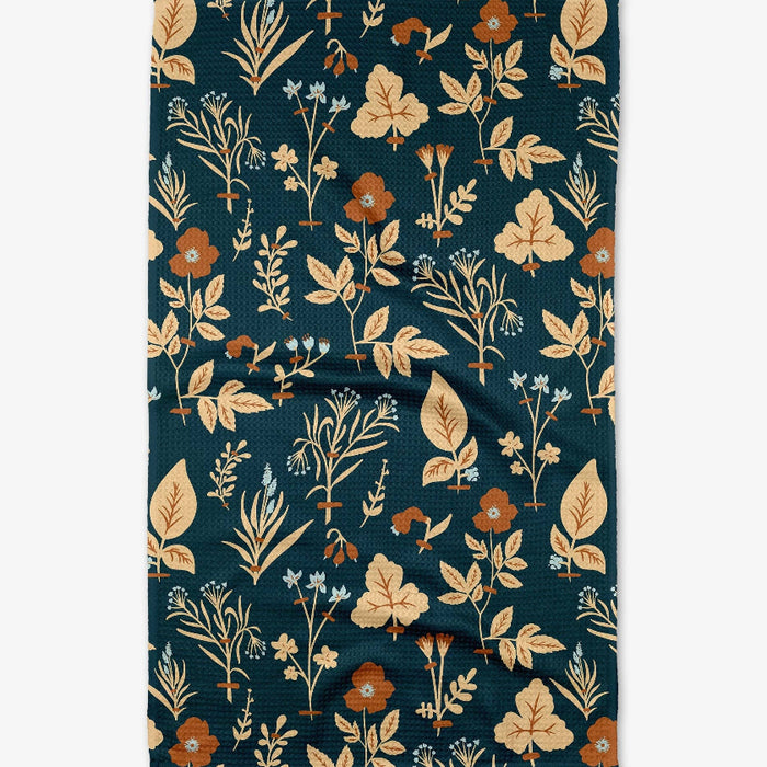 Floral patterned towel with leaves and flowers on a dark blue background