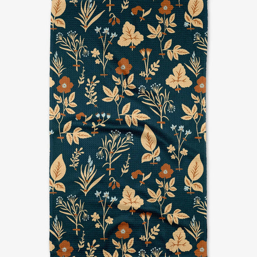 Floral patterned towel with leaves and flowers on a dark blue background