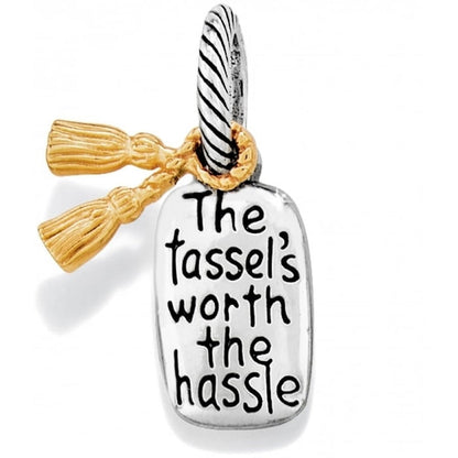 Brighton charm with silver-tone tag reading The tassel's worth the hassle and gold-tone tassel on a white background