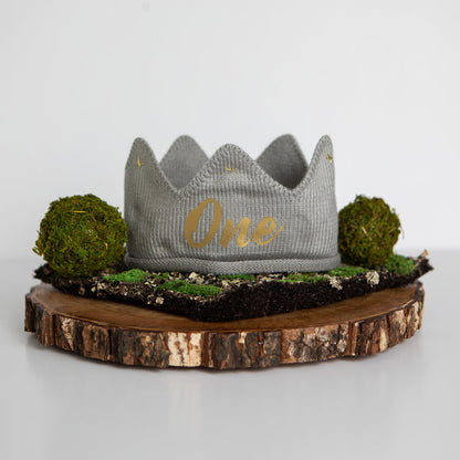 Gray knitted crown with One in gold lettering and gold accents