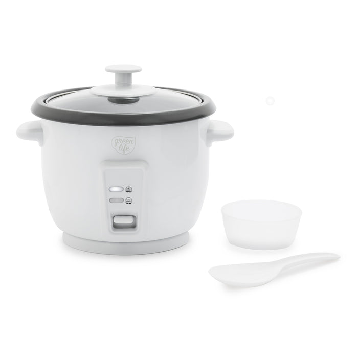 White rice cooker with glass lid, ceramic pot, measuring cup, and rice paddle shown together.