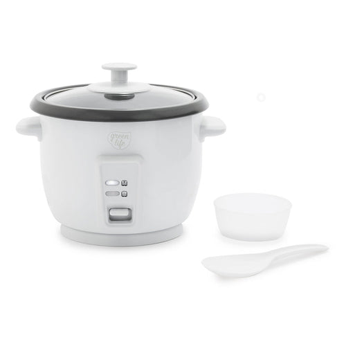 White rice cooker with glass lid, ceramic pot, measuring cup, and rice paddle shown together.